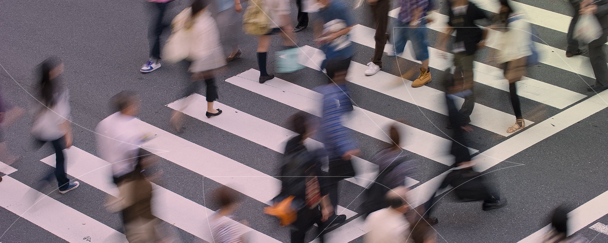 blurry image of people walking on crosswalk