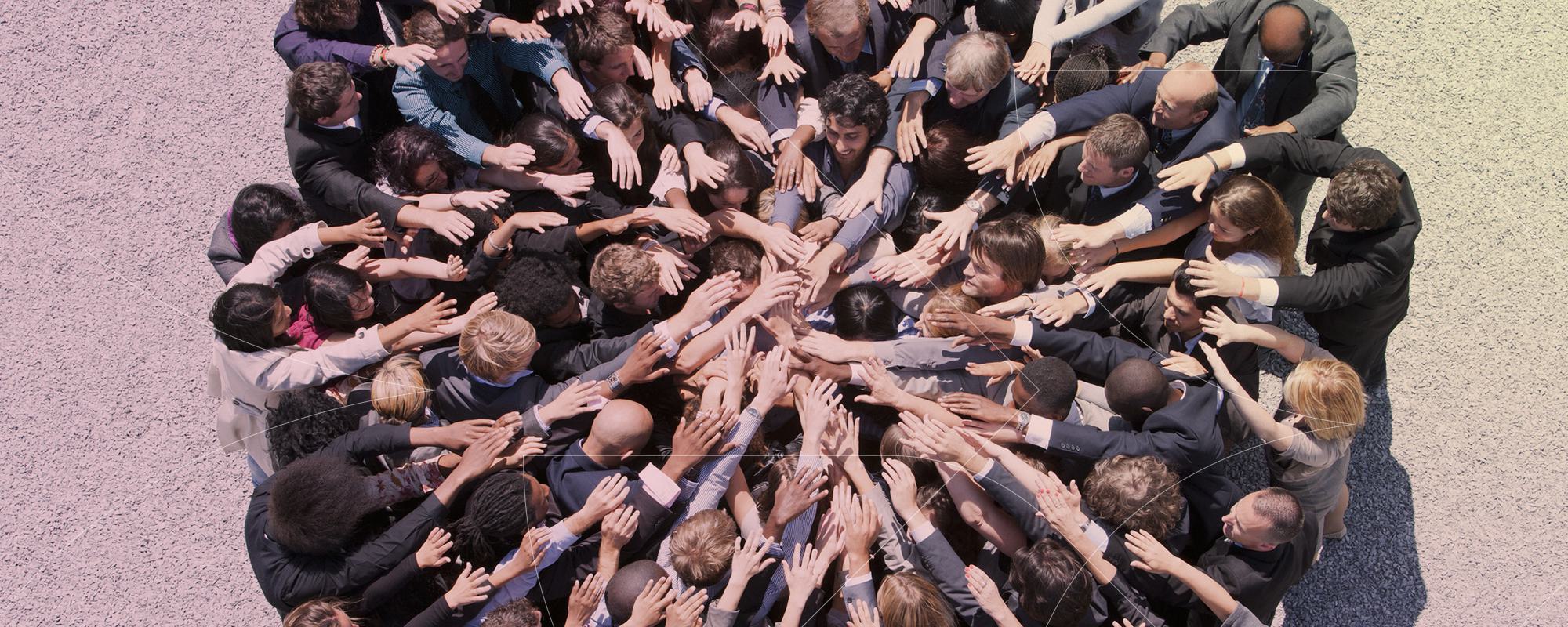 team putting hands together in circle