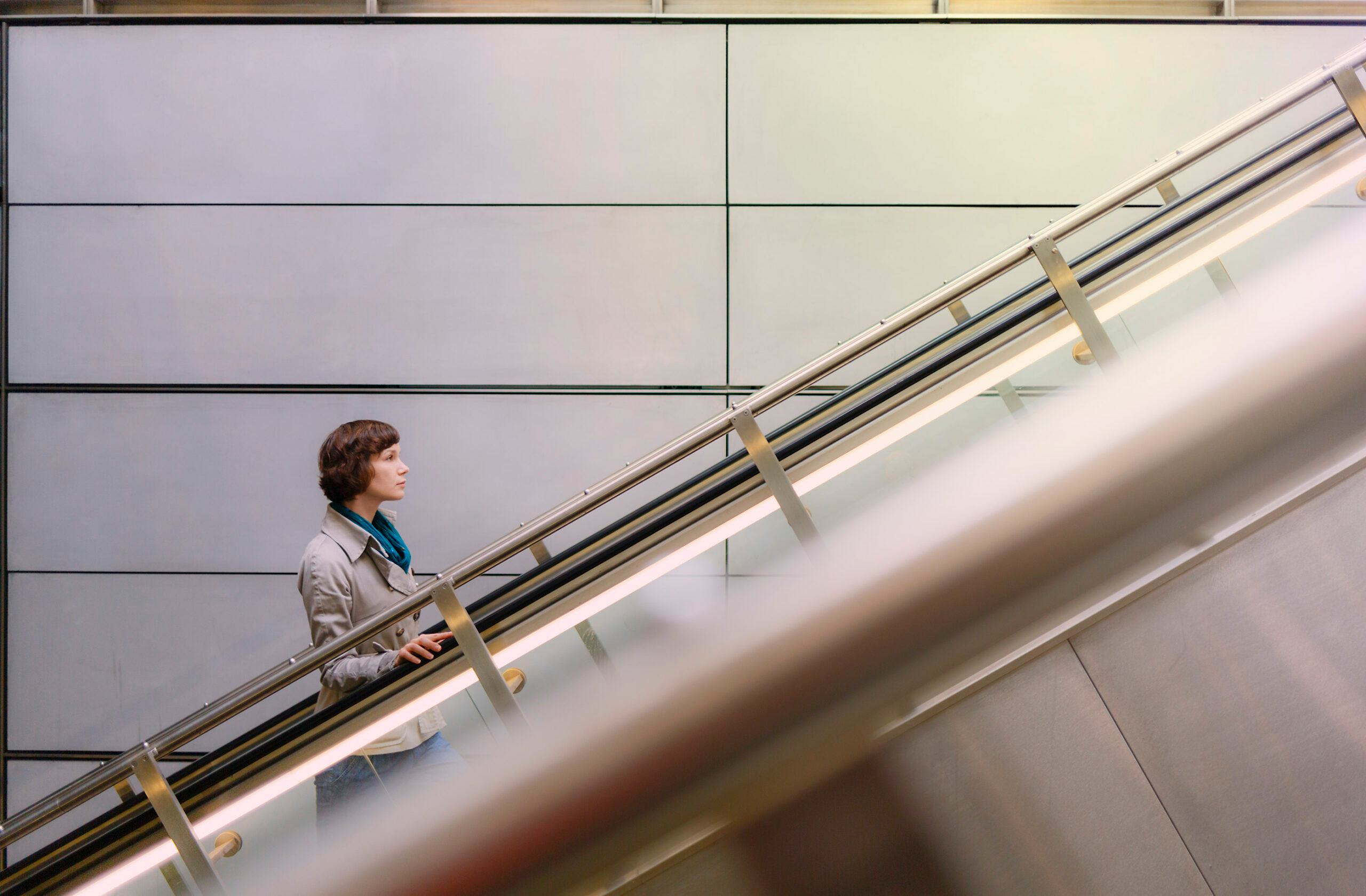 Person going up escalator